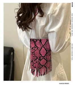 Close-up of pink and black snakeskin pattern square bag with decorative long fringe detail