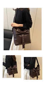Close-up of brown tote bag featuring oversized bow decoration and metallic stud details