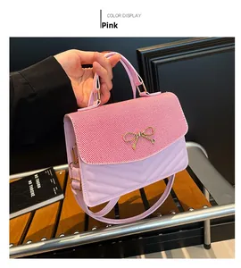 Detail of pink small square bag with golden butterfly accent and V-shaped quilting