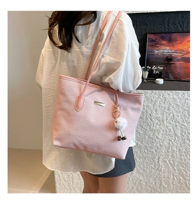 Borsa tote rosa intrecciata con ciondolo in peluche e logo metallico sul lato