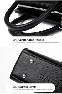 Detail of black pebbled leather handbag featuring padded handle and metal bottom studs
