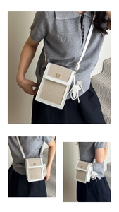 Close-up of canvas mini bag with leather trim, gold floral buckle and pearl pendant