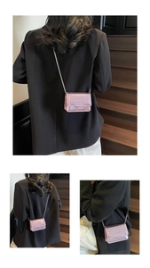 Detailed views of pink crocodile embossed mini bag with elegant silver chain strap