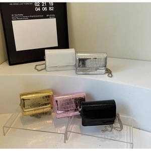 Detailed view of crocodile pattern mini chain bags in gold, silver, pink, and black