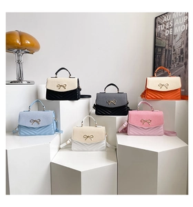 Quilted mini crossbody bags in various colors displayed on modern geometric pedestals