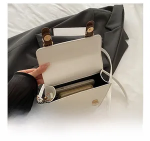 Detail showing spacious interior capacity of white PU leather bag for phone and wallet