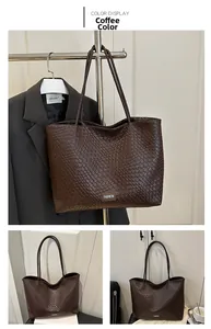 Detail of woven texture tote bag in brown with fashion metal plate and long shoulder straps