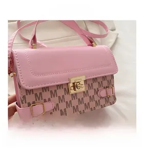 Detail of pink and beige monogram square bag with a golden twist-lock and fine texture