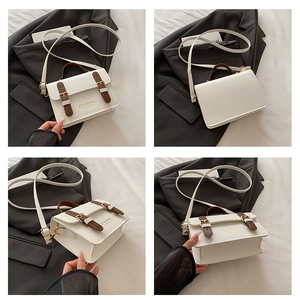 Detail shots of off-white retro flap crossbody bag with brown leather straps and handle