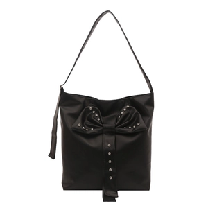 Black shoulder bag with a large rhinestone bow, minimalist design on white background