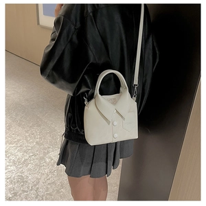 Crossbody view of white shirt-style handbag featuring collar and button details