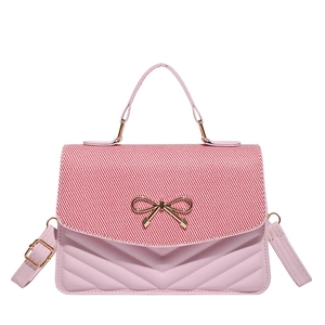 Pink crossbody bag with striped woven flap and gold bow detail for summer style