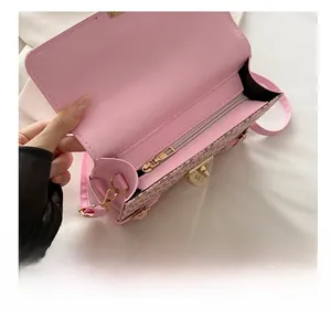 Detailed interior of a pink monogram crossbody bag featuring a smooth gold metal zipper