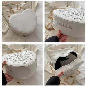 Detailed views of heart-shaped white crossbody bag with spider web embroidery and chain
