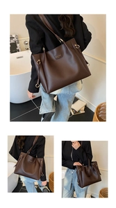 Detail of dark brown tote bag with gold hardware buckle and adjustable side strap