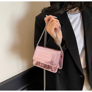 Close-up of pink faux-crocodile leather mini crossbody bag with silver chain strap