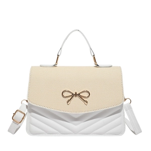Minimalist beige straw patchwork crossbody bag with gold bow and V-quilted details