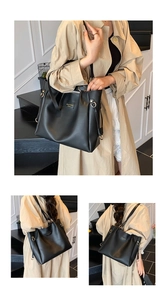 Detail of minimalist black leather tote bag with gold buckle and slim shoulder strap