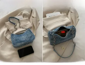 Detailed interior and exterior view of denim shoulder bag showing storage for essentials