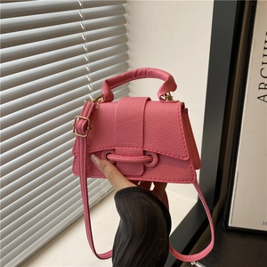 Pink lychee texture mini crossbody bag with top handle and metal buckle closure