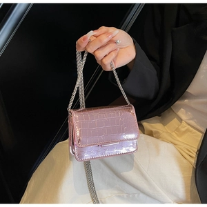 Close-up of metallic pink croc-embossed mini bag with elegant silver chain strap