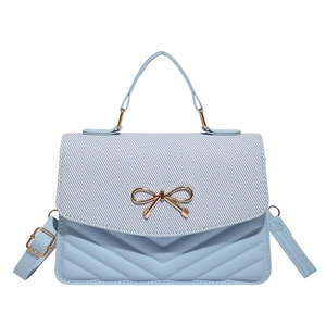 Light blue contrast crossbody bag with V-quilted pattern and gold bow accent