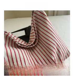 Close-up of the red striped canvas fabric showing detailed texture of the tote bag