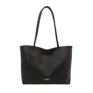 Minimalist black tote bag with crocodile texture and fashion label on white background