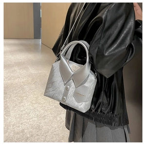 Silver shirt-style crossbody bag with collar and button detail worn by a model