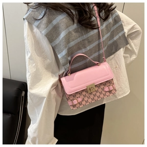 Pink vintage monogram small square bag with gold hardware shown on a model