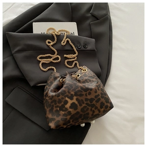 Close-up of leopard print bucket bag with gold chain strap and pearl detail