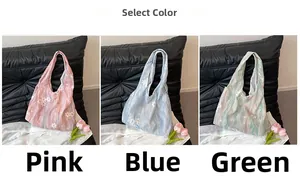 Vue détaillée des sacs cabas en rose, bleu et vert avec imprimé marbré et broderie florale