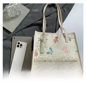Flat lay of Chinese style tote bag showing size comparison with iPad and everyday items