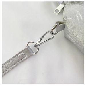 Detail of silver metallic lobster clasp and textured strap on a chic crossbody bag