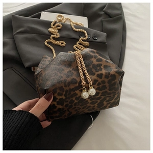 Detail of leopard print bucket bag with gold chain strap and pearl bead closure