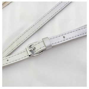 Close-up of adjustable silver metal buckle and pearlescent leather strap stitching