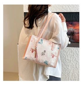 Detail of pink embroidered tote bag with traditional butterfly and goldfish patterns