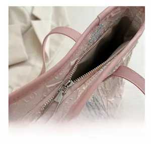 Detail view of pink tote bag with smooth metal zipper and spacious inner compartment