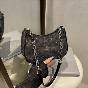 Fashionable black sequin shoulder bag with silver chain strap and minimalist design