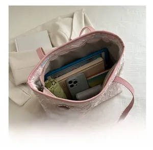 Top-down view of large capacity tote bag interior with tablet, umbrella and wallet