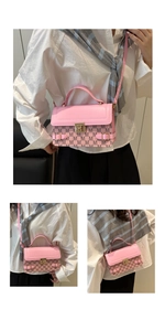 Detail of pink leather handbag showing M-monogram pattern and golden twist lock closure