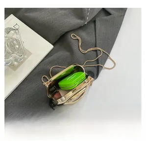 Close-up of gold mini hard-shell evening bag interior showing lipstick storage space