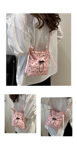 Detailed view of pink quilted drawstring tote bag with black bow polka dots and strap