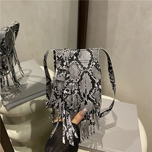 Modern snakeskin crossbody bag with fringe tassel detail and adjustable strap