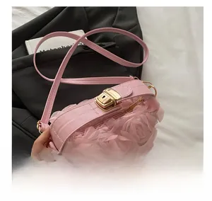 Close-up of pink rose floral evening bag featuring a premium gold metal clasp and soft strap