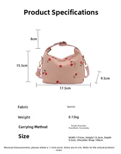 Pink corduroy handbag detail with cherry print, showing size dimensions and strap length
