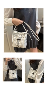 Detailed view of white quilted shoulder bag with drawstring and black bow embroidery