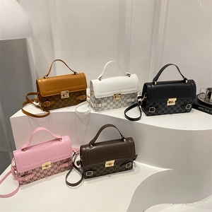 Retro monogram crossbody bag in five colors with gold lock on white display steps