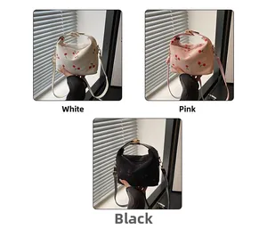 Detailed comparison of corduroy shoulder bags in white, pink, and black with cherry embroidery