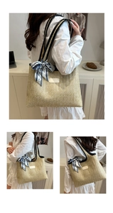 Detail of woven straw tote bag with V-pattern texture, black leather straps and silk scarf